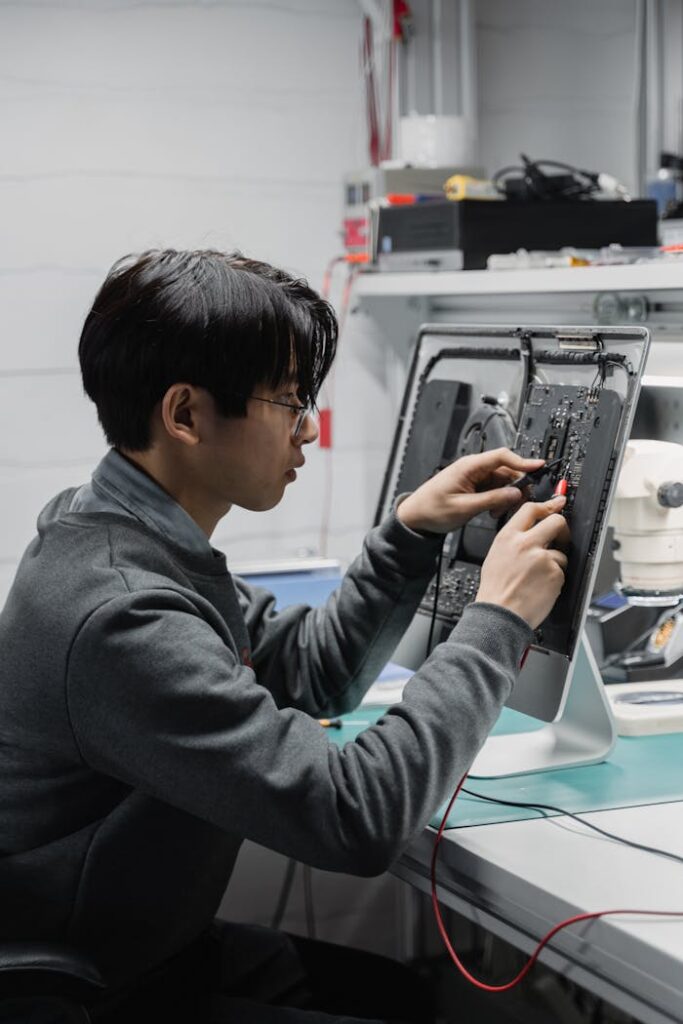 Man in Black Hoodie Using Smartphone